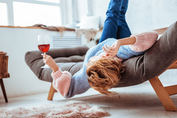 Nice delighted woman enjoying her red wine