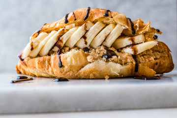 Croissant Sandwich with Banana, Peanut Butter and Chocolate Sauce.