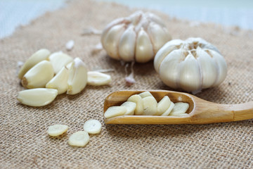 Fototapeta na wymiar Natural garlic on wooden spoon on the table