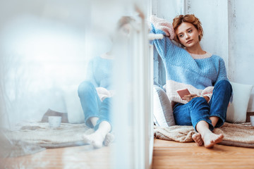 Sad young woman waiting for a message