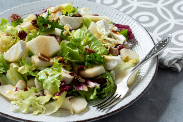 Mix of salad with walnut, pear and goat cheese.