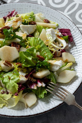 Mix of salad with walnut, pear and goat cheese.