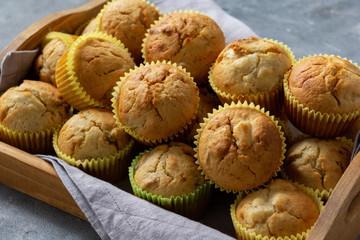 Homemade banana muffins on wooden tray. 