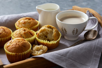 Homemade banana muffins on wooden tray. 