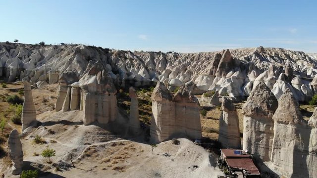 Aerial shot of love Valley in Cappadocia, Turkey. Drone shot of tourist destination of sandstone phallic stone pillars in lovers valley. Unusual stone geological formations.