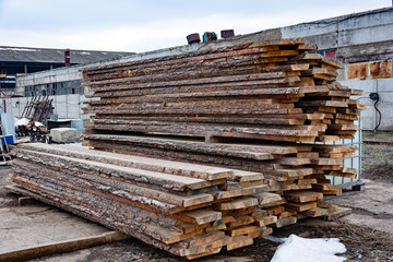 Sawmill. A stack of wooden boards in the open air. Sawing, lumber.