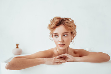 Attractive good looking woman relaxing in the bathtub