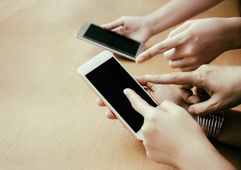 The abstract art design background of Human hands pointing to screen of mobile phone,blurry light around.