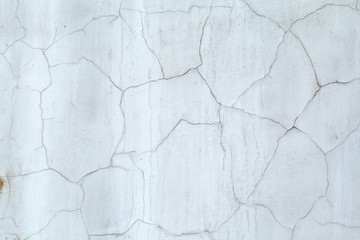 Obraz premium Gray concrete wall covered cracked plaster. Cracks on the wall resemble a map of the world with the borders of States