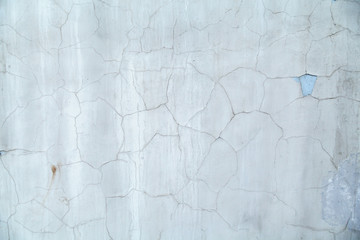 Gray-blue concrete wall, covered with cracks in the plaster reminiscent of a map of the world with the borders of States