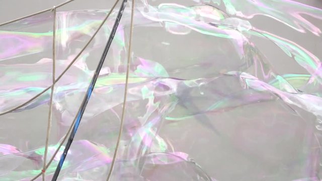 Abstract white background with soap bubbles, pubblic entertainment. Slow motion