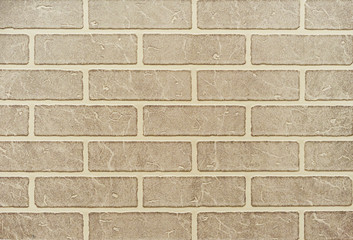 Texture of a light brown brick wall for background.