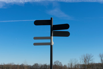 Pole with five blank signposts to fill in text and in a landscape