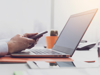 Fototapeta premium Corporate businesswoman working and connecting with her smartphone