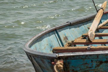 Old rusty fishing boat with flaking paint on the bank of the Nile in Sudan