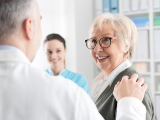 Smiling senior lady meeting a doctor at the clinic