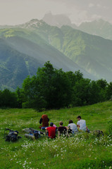 Fototapeta premium Friends resting while hiking in the caucasus mountains