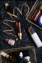 set of nature precious oils and  care cosmetics on black background .