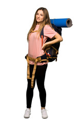 Full body Young backpacker woman suffering from backache for having made an effort on isolated background
