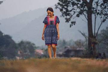 portrait of beautiful asian woman in dress north in lanna thai style with walking in nature in smile and relaxing emotional