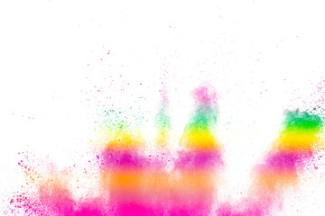 Abstract multi color powder explosion on white background.  Freeze motion of  dust  particles splashing. Painted Holi in festival.