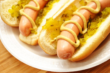 Hot Dogs with Relish and Mustard On a White Plate