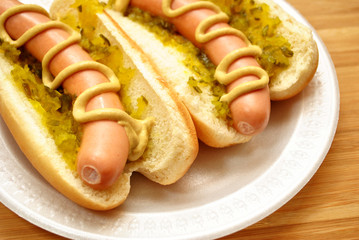 Hot Dogs with Relish and Mustard On a White Plate