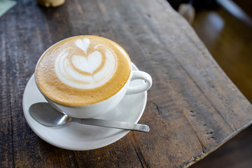 Cup of coffee on old wooden background
