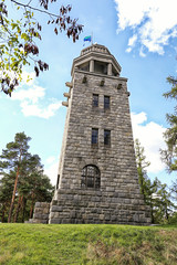 Fototapeta na wymiar Tall walled outlook tower with blue flag