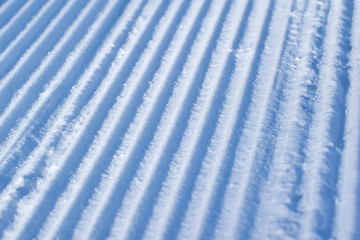 Texture of fresh stripped snowcat traces on snow. ski resort concept