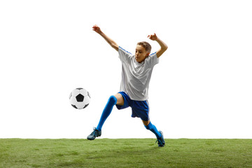 Young boy with soccer ball running and jumping isolated on white studio background. Junior football soccer player in motion