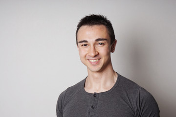 happy smiling young man looking at camera                      