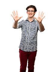 Naklejka premium Teenager man with flower shirt and glasses counting ten with fingers over isolated white background