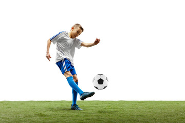 Young boy with soccer ball running and jumping isolated on white studio background. Junior football...