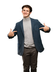 Teenager man with turtleneck proud and self-satisfied over isolated white background