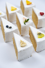 Delicious creamy minimal white cake with fruit on white background.