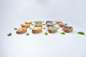 Delicious creamy colourful minimal cake roll on white background.