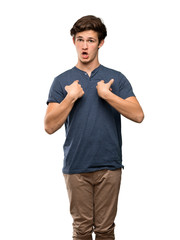 Fototapeta premium Teenager man with surprise facial expression over isolated white background