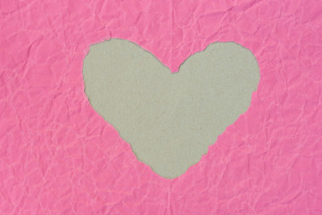 heart shape  hole on piece on pink paper