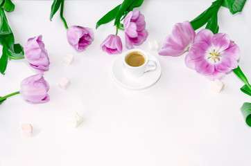 cup of black coffee and tulip flowers
