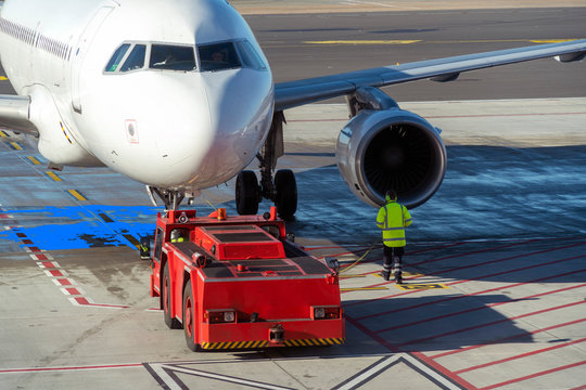 No brand aircraft undocking from jet bridge and preparing to take off