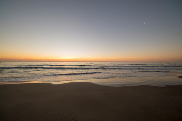 Fototapeta na wymiar The beach of Barcelona at the beautiful sunrise