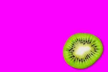 One piece of fresh ripe kiwi on pink background with copy space for your text