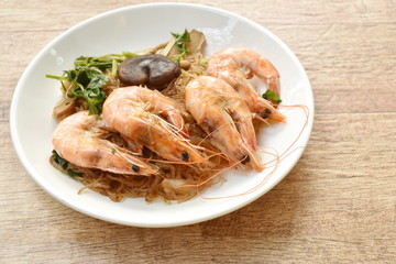 shrimp steamed with glass noodle and ginger on white plate