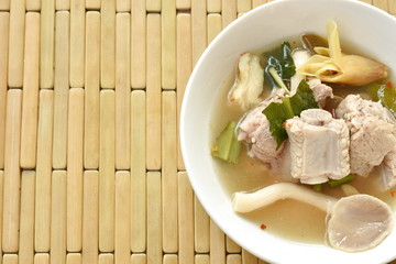 hot and spicy pork bone with tamarind and Thai herbs soup on glass bowl