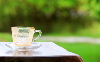 Empty coffee cup after drink on wood table at outdoor of coffee shop