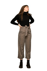 Full-length shot of Pretty girl suffering from backache for having made an effort on isolated white background