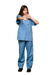 Full-length shot of Young nurse is a little bit nervous and scared stretching hands to the front on isolated white background