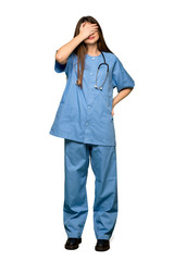 Full-length shot of Young nurse covering eyes by hands. Do not want to see something on isolated white background