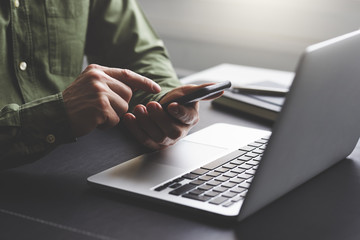 A man with his mobile phone in the office